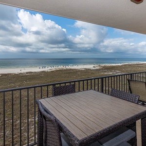 View from the balcony overlooks the beach, offering a serene spot to enjoy the view of the gentle waves and white sand