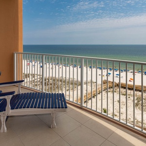 Recline on the balcony lounger and watch the gulf and colorful beach umbrellas dotting the shore