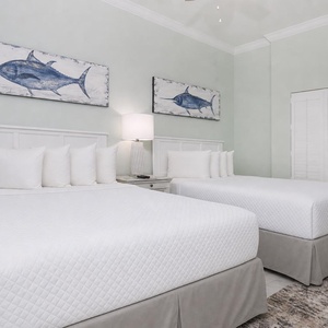 Choose either of the two comfortable queen beds and read under the warm lamp beside a pair of nautical wall prints