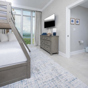 Unwind with a movie in this cozy bunk room with fun decor and a fluffy twin over double bunk