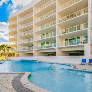 Relax by the inviting pool with views of the lush surroundings and spacious balconies perfect for your getaway