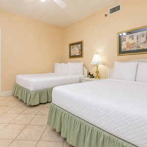 Rest in this comfortable guest room with two double beds, soft linens, and cozy decor
