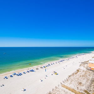 Cool gulf waters stretch beneath your balcony as gentle coastal breezes brush your skin on this clear day