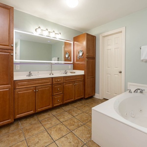 Indulge in relaxation in the master bath with a refreshing walk-in shower and soothing jetted tub