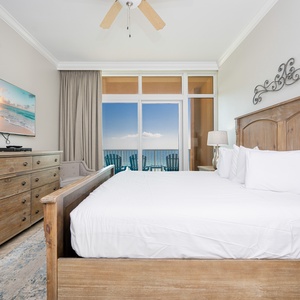 Relax in the master suite, featuring a king bed and a beachfront view from your balcony with comfortable seating