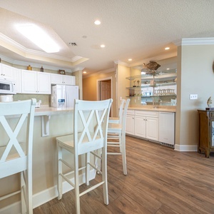 Sip your morning coffee at the breakfast bar and get ready for a beach day in this stylish space
