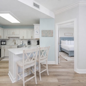 Soft light fills the kitchen where you can prepare meals and chat with loved ones nearby in the master suite
