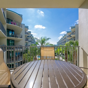 Sip your morning coffee on the balcony, surrounded by lush palms and inviting views of the sparkling pool below