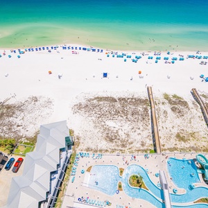 Discover the vibrant pool area with gradual entry, a refreshing lazy river, and fun waterslide on the beach