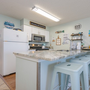 The kitchen features granite countertops, stainless appliances, and a cozy dining area, perfect for enjoying meals together