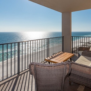 Relax on the balcony with comfortable seating and enjoy expansive views of the tranquil waters and shoreline