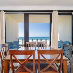 Gather around the dining table, enjoying laughter and conversations while gazing out at the stunning coast view