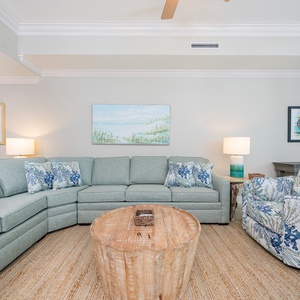 Relax in the cozy seating, where family moments unfold while enjoying the beach vibe and gentle coastal light
