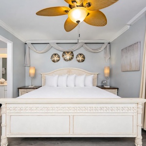 Calm colors and gentle lighting create a serene retreat in the master suite with a king bed