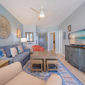 Imagine watching your favorite movie while sinking into cushions in the living room with coastal art around you