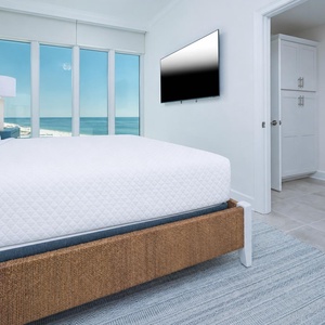 Stream your favorite show from this king guest suite and relax with stunning beach views