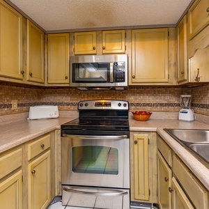 Enjoy creating delicious meals in this charming kitchen, adorned with inviting decor and ample prep space
