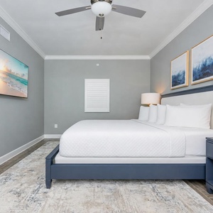 Unwind in this stylish guest bedroom featuring a king bed, sleek design, and a large TV to stream your favorite show