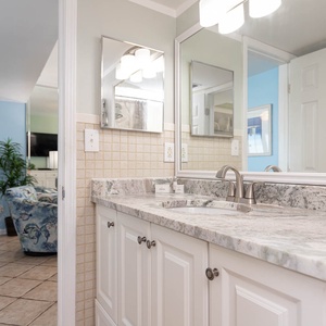 Refreshing master bathroom featuring a stylish granite countertop and modern fixtures, perfect for relaxation