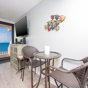 Enjoy a relaxing moment at the cozy seating area with a stunning beachfront view and a flat-screen TV for entertainment