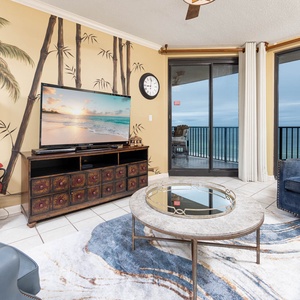 Relax in the inviting living area featuring a large TV, stylish decor, and views through expansive windows