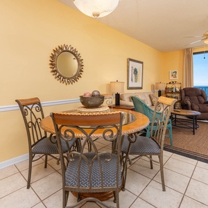 Gather around the round dining table, where you can enjoy meals with a view of the beach through large windows