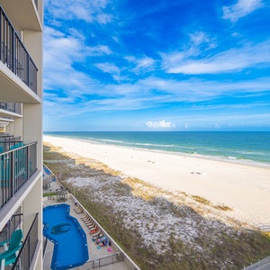 Watch the distant sailboats drift along the calm coast and families stroll along the white sand