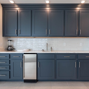 Mix chilled drinks at the wet bar using the undercounter fridge, sink, and ample counter space
