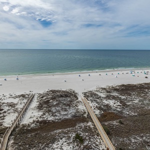 Seemingly endless views of the beach showcase white sand and colorful umbrellas, inviting relaxation