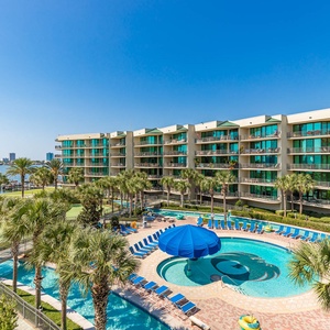 Bask in the sunshine from your balcony, overlooking the inviting pool area and shimmering bay beyond