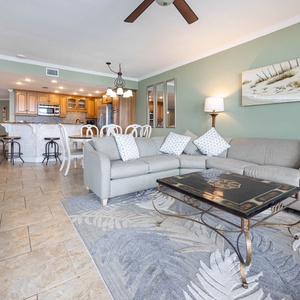 Relax in the spacious living area with comfortable seating and a view of the kitchen and dining space nearby