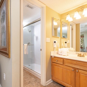 Luminous master bath featuring a walk-in shower, ample counter space, and decorative accents for a refreshing experience