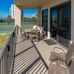 Patio area with comfortable seating and enjoy views of the nearby tennis courts and grassy area