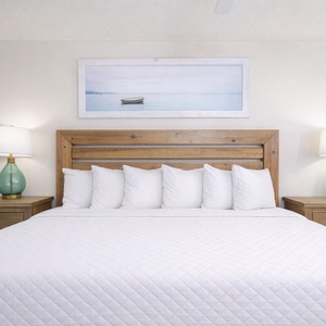 Drift into relaxation on the plush king bed, surrounded by soothing decor, ready to recharge for your coastal adventures