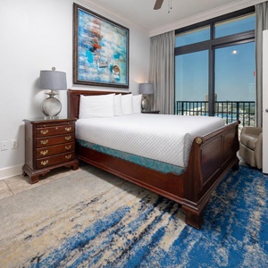 This bedroom features a plush queen bed, elegant decor, and a stunning view from large windows, perfect for relaxation