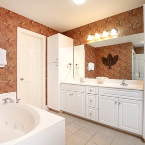 Refresh in the master bath after a day at the beach with a soothing jetted tub and relaxing walk-in shower