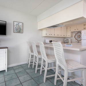 This inviting kitchen features a breakfast bar with seating, perfect for casual meals and gatherings