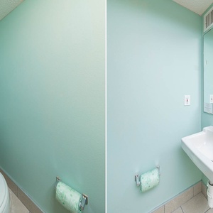 Additional half bath with soothing teal walls, a clean sink area, and fresh towels for your convenience