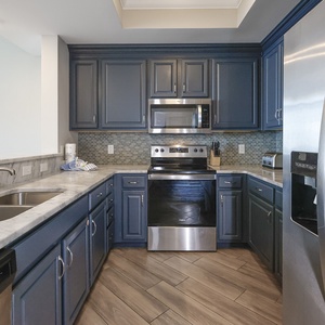 Experience culinary creativity in this stylish kitchen, where sleek countertops invite delightful meal preparations