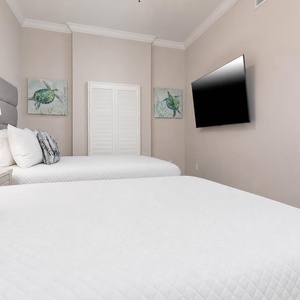 Unwind after a day at the beach with a good movie and cozy queen beds
