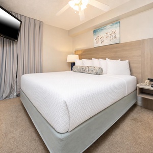 Unwind in this serene bedroom featuring a king bed, soft linens, and a cozy atmosphere for restful nights