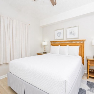 Serene guest bedroom featuring a queen bed, soft linens, and coastal decor for a restful getaway