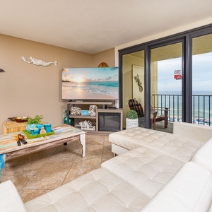 Coastal breezes brush past you in this living space as you enjoy a movie beside your balcony