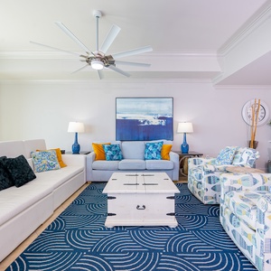 Gather in this welcoming living space and enjoy stunning beach views from the balcony