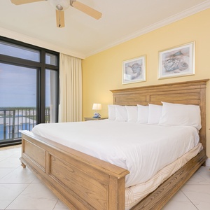 Master bedroom featuring a king-size bed and stunning views through the balcony doors