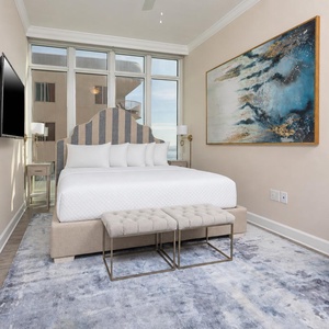 Relax on the cozy king bed in this guest suite with coastal views and stream your favorite shows after a beach day