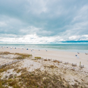 This stunning beachfront view showcases soft sands and gentle waves, perfect for relaxation and beach activities