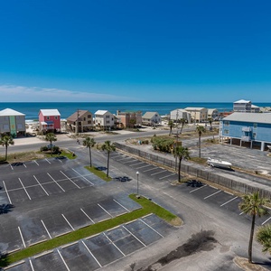 This view showcases colorful beach houses along the shore, inviting guests to enjoy a vibrant coastal experience