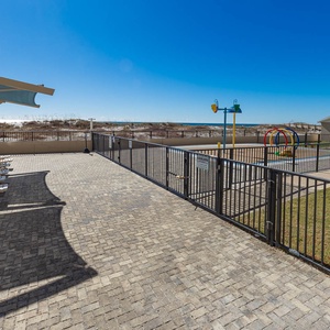 Lounge under shaded areas by the pool, enjoying views of the beach and nearby splash park for family fun