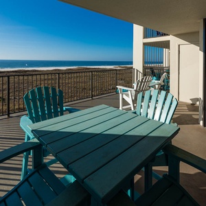 Relax on the extended balcony, enjoying direct views of the beach and the calming waves of the gulf